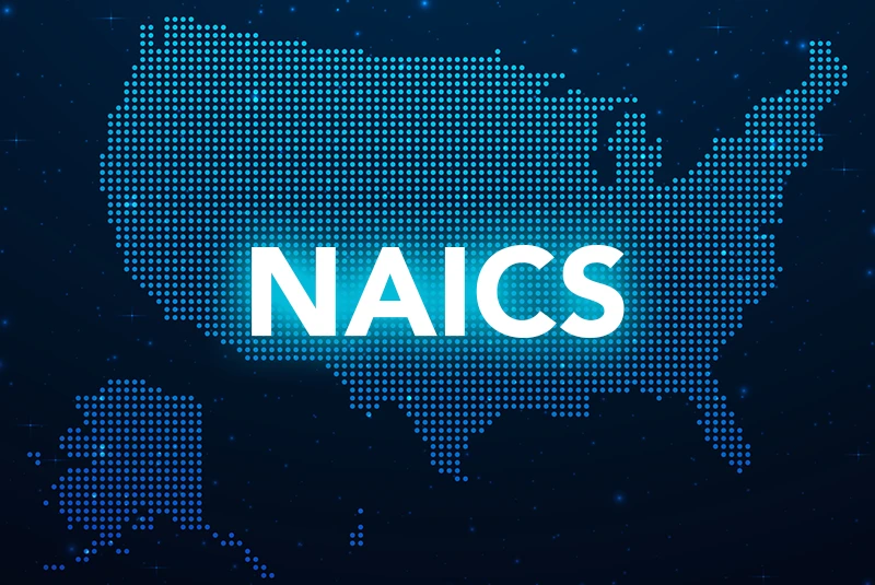 An image of the united states map which is made of tiny blue dots on a dark background. The letters N A I C S are overlaid on the map.